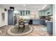 Stylish kitchen boasts two-tone cabinets, stainless steel appliances, and a breakfast nook, offering a functional and appealing space at 717 Anderson St, Castle Rock, CO 80104