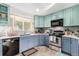 Modern kitchen features two-tone cabinetry, stainless steel appliances, and a herringbone backsplash, combining style and functionality at 717 Anderson St, Castle Rock, CO 80104