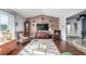 Inviting living room featuring wood floors, a wood accent wall, vaulted ceilings, and a comfortable seating arrangement at 717 Anderson St, Castle Rock, CO 80104
