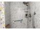 Shower area featuring a grab bar, handheld shower head, and toiletry shelves at 717 Anderson St, Castle Rock, CO 80104