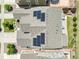 Drone shot of rooftop solar panels, fenced back yard, stone patio and garden at 14565 Vancouver Pl, Parker, CO 80134