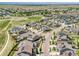 Expansive aerial view of a neighborhood featuring solar panels, green spaces, and mountain views at 14565 Vancouver Pl, Parker, CO 80134