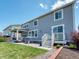 Back exterior featuring a well-manicured lawn, patio area, and multi-story home at 14565 Vancouver Pl, Parker, CO 80134