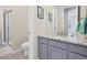 Bathroom featuring a granite countertop, modern fixtures, and a glass-enclosed shower at 14565 Vancouver Pl, Parker, CO 80134