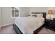 Comfortable bedroom featuring plush bedding, a large window, and dark wood furniture at 14565 Vancouver Pl, Parker, CO 80134