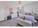 Inviting bedroom with a canopy bed, pink accent wall, and stylish furnishings at 14565 Vancouver Pl, Parker, CO 80134
