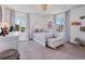 Charming bedroom featuring a canopy bed, bright natural light, and whimsical decor at 14565 Vancouver Pl, Parker, CO 80134