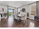 Dining area with a modern table set, hardwood floors, and a view of the backyard at 14565 Vancouver Pl, Parker, CO 80134