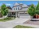 Charming two-story home with a well-manicured lawn, mature trees, and a two-car garage at 14565 Vancouver Pl, Parker, CO 80134