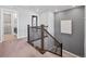 Upstairs hallway with stairs, neutral color palette, and access to laundry and bathroom at 14565 Vancouver Pl, Parker, CO 80134