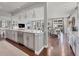 Open concept kitchen featuring an island bar connecting to living and dining spaces at 14565 Vancouver Pl, Parker, CO 80134
