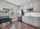 Modern kitchen featuring stainless steel appliances, white cabinets, and granite countertops at 14565 Vancouver Pl, Parker, CO 80134