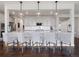 Bright kitchen bar featuring granite countertops and pendant lights at 14565 Vancouver Pl, Parker, CO 80134