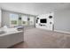 Spacious living room with a white sectional sofa, large windows and a modern entertainment center at 14565 Vancouver Pl, Parker, CO 80134