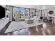 Open living space featuring hardwood floors, comfortable seating, and bright windows at 14565 Vancouver Pl, Parker, CO 80134