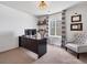 Cozy home office featuring a sleek black desk, comfortable seating, and stylish decor at 14565 Vancouver Pl, Parker, CO 80134