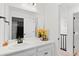 Clean bathroom featuring a modern vanity, large mirror, and a view of the staircase at 6454 Leathers Ln, Parker, CO 80134