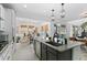 Bright kitchen with granite counters, stainless appliances, and an island that opens to the dining area at 6454 Leathers Ln, Parker, CO 80134