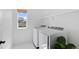 Bright laundry room with modern washer and dryer and a convenient window with natural light at 6454 Leathers Ln, Parker, CO 80134
