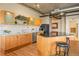 Modern kitchen with wood cabinets, granite countertops, and island at 1499 Blake St # 4O, Denver, CO 80202