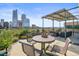 Urban rooftop deck with seating, plants, and city views at 1499 Blake St # 4O, Denver, CO 80202