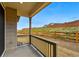 Cozy covered back porch with views of landscaped backyard and neighborhood beyond the fence at 17156 W 92Nd Loop, Arvada, CO 80007
