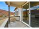 Inviting covered porch, perfect for relaxing, offering a serene outdoor living space and fenced perimeter at 17156 W 92Nd Loop, Arvada, CO 80007