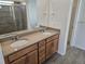 Bathroom with double sink vanity, large mirror, and tiled shower at 17156 W 92Nd Loop, Arvada, CO 80007