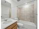 Well-lit bathroom featuring tile surround, a modern vanity, and a shower-tub combination at 17156 W 92Nd Loop, Arvada, CO 80007