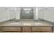 Bright bathroom showcasing double sinks with modern faucets and a large mirror at 17156 W 92Nd Loop, Arvada, CO 80007
