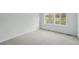 Empty bedroom featuring neutral carpet, base molding, and plenty of natural light from the surrounding windows at 17156 W 92Nd Loop, Arvada, CO 80007