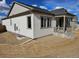A charming home with neutral siding, a covered porch and landscaped yard at 17156 W 92Nd Loop, Arvada, CO 80007