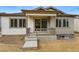 Charming covered front porch with modern railing accents the home's curb appeal, inviting you inside at 17156 W 92Nd Loop, Arvada, CO 80007