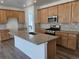 Charming kitchen boasts stainless appliances, a large island with seating, and ample cabinet space at 17156 W 92Nd Loop, Arvada, CO 80007