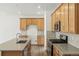 Stylish kitchen with wood cabinets, granite countertops, stainless steel appliances, and a central island at 17156 W 92Nd Loop, Arvada, CO 80007