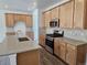 Modern kitchen showcasing stainless steel appliances, light countertops, and ample cabinet storage at 17156 W 92Nd Loop, Arvada, CO 80007