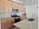 Kitchen features stainless steel appliances, white backsplash and light countertop with a kitchen island at 17156 W 92Nd Loop, Arvada, CO 80007