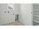Well-lit laundry room with hookups and shelving, ready for appliances and organization at 17156 W 92Nd Loop, Arvada, CO 80007