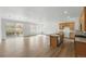 Open-concept living room featuring wood floors, a chandelier, large windows, and access to the outdoor deck at 17156 W 92Nd Loop, Arvada, CO 80007