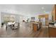 Bright, open-concept living space with hardwood floors, and adjacent kitchen and dining areas at 17156 W 92Nd Loop, Arvada, CO 80007