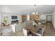 Open-concept living area with hardwood floors, modern lighting, and access to kitchen at 17156 W 92Nd Loop, Arvada, CO 80007