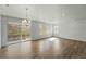 Bright living room featuring wood floors, modern chandelier, and large sliding glass door to access the outdoor deck at 17156 W 92Nd Loop, Arvada, CO 80007