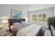 Comfortable main bedroom featuring a serene color scheme, carpet, and bright windows at 17156 W 92Nd Loop, Arvada, CO 80007