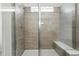 Modern bathroom featuring a tiled shower with glass enclosure and a convenient built-in bench at 17156 W 92Nd Loop, Arvada, CO 80007