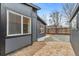 This backyard features both a gravel and stone patio as well as exterior painted in a modern color at 5523 Tejon St, Denver, CO 80221