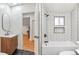 Bathroom features a modern vanity, black fixtures, wood design, and black tile flooring at 5523 Tejon St, Denver, CO 80221