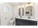 Bathroom featuring double vanity, modern mirrors, black fixtures, and tile shower at 5523 Tejon St, Denver, CO 80221