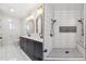 Updated bathroom featuring double sinks, modern fixtures, and a stylish updated shower with dual shower heads at 5523 Tejon St, Denver, CO 80221