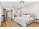 Comfortable bedroom featuring a mirrored closet and bed with white bedding and ensuite at 5523 Tejon St, Denver, CO 80221