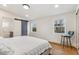 Bright bedroom featuring warm wood floors, modern barn door, and serene natural light at 5523 Tejon St, Denver, CO 80221